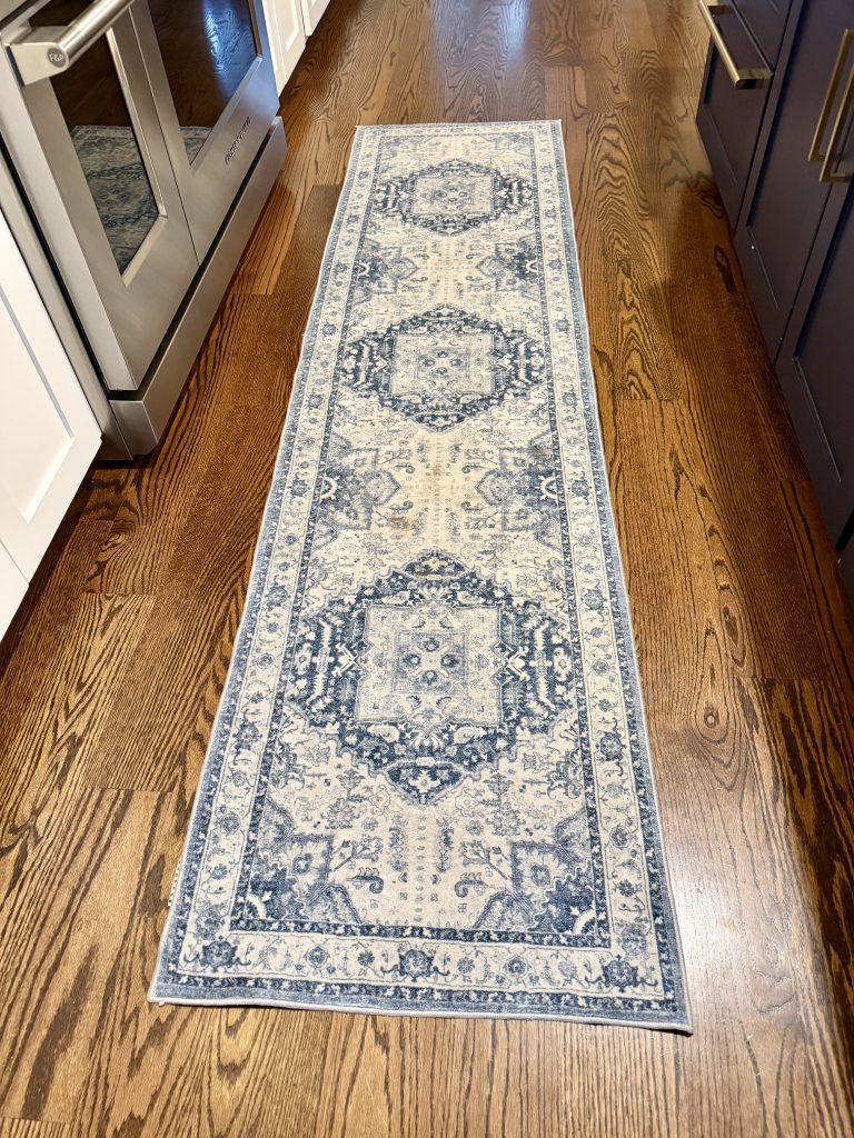 Washable kitchen runner before washing showing stains and heavy foot traffic