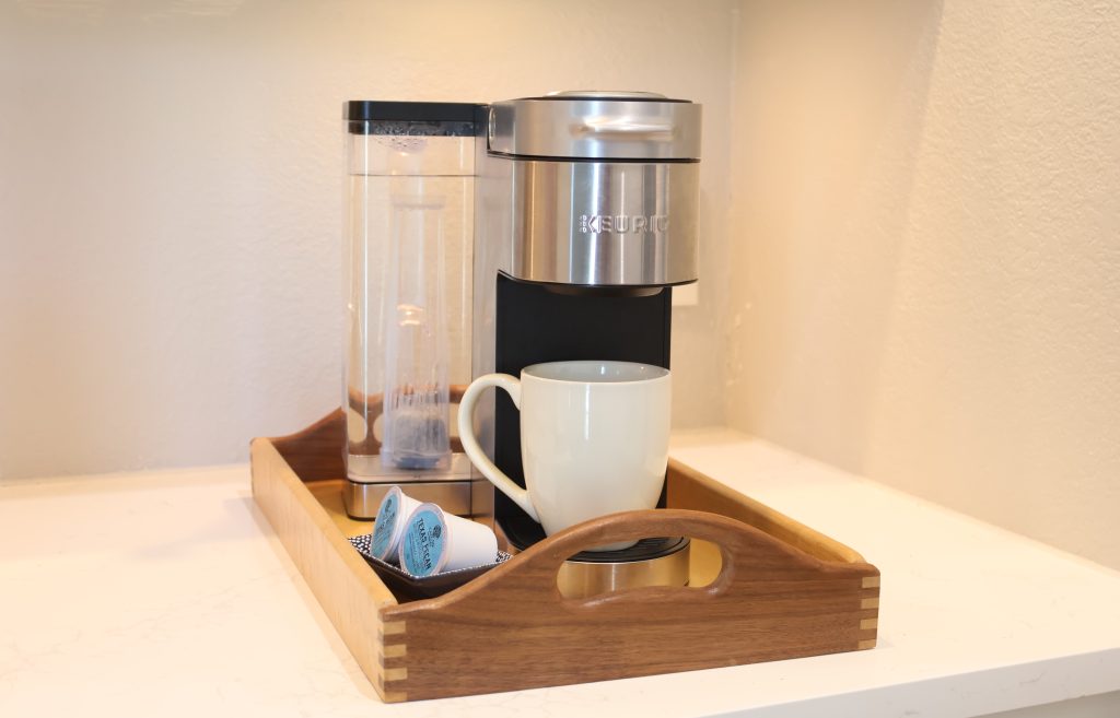 Airbnb kitchen coffee maker setup with mugs and guest essentials for vacation rental