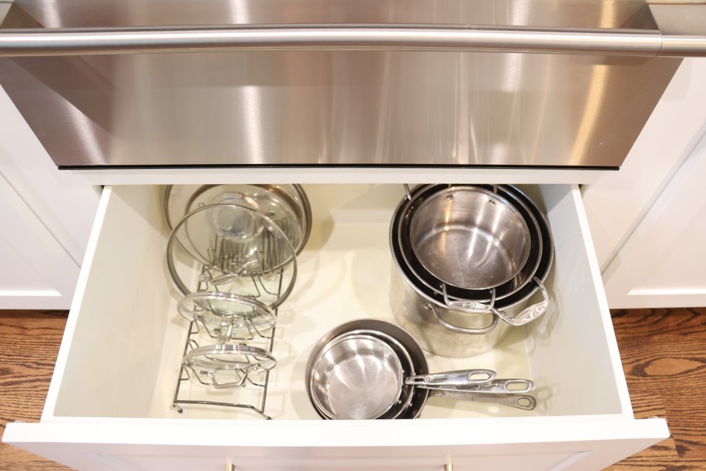 Airbnb kitchen cookware essentials including pans and pots for vacation rental guests