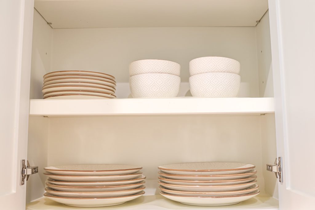 Airbnb kitchen dishes and bowls stocked for guest-ready vacation rental setup